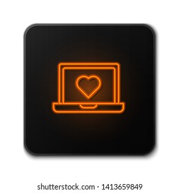 Orange neon sign on dark background  Laptop with heart icon