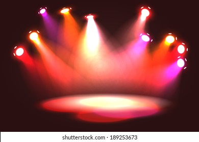 Orange, pink, violet and red spotlight projecting on empty stage