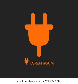 Orange plug as logo with copy space on black background. Energy and Electricity