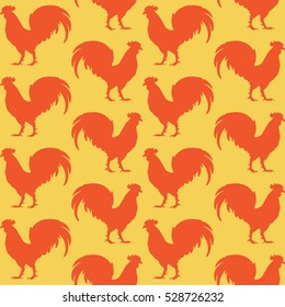 Orange silhouettes of rooster on yellow background seamless pattern. Cockerel seamless pattern.
