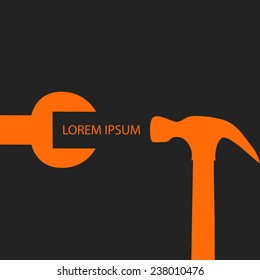 Orange spanner and hammer  on black background as repair symbol
