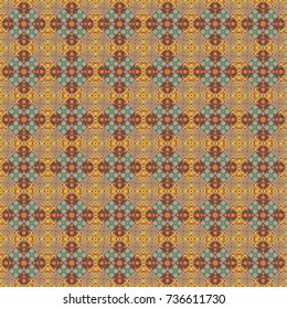 Orange, yellow and brown ethnic geometric motif seamless pattern in orange, yellow and brown on abstract background.