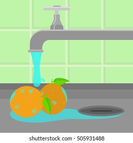 Oranges being cleaned and washed in a sink in a kitchen. Running tap water.