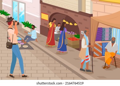 Ordinary citizens, tourists and photographer at authentic marketplace, indian market with people and different shops with ancient cityscape at background. Fabrics, carteps, spices, sweets, vegetables