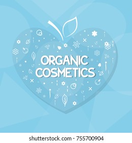 organic cosmetics and herbs in the shape of heart on a blue background