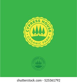 Organic farm emblem. Cypress tree house logo. Cypress trees and a farm in a yellow badge