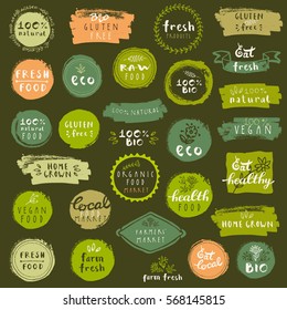 Organic food labels set. Vector fresh healthy food icons. Vintage badges for restaurant menu or food package. Eco friendly raw vegan products logo templates. Hand lettering, calligraphy, brush smears