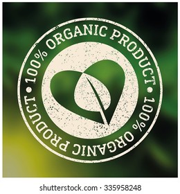 Organic Product 100%, Vector Logo On Blurred Background Leaves