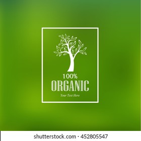 Organic tree label on blurry green background.