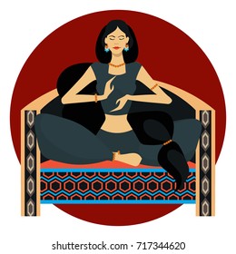 Oriental beauty sitting on the couch in lotus position on white background with a round substrate