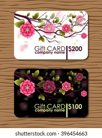 Oriental designed gift card with branches of japanese cherry flowers. 