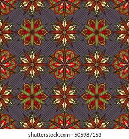 Oriental floral ornament. Seamless pattern of geometric chrysanthemum flowers in shades of red, green & ivory on dark purple background. 
