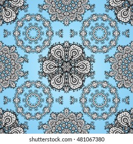 Oriental seamless pattern of white flowers and mandalas. Vector blue background.
