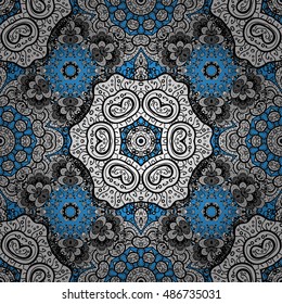 Oriental seamless pattern of white flowers and mandalas. Vector blue background.