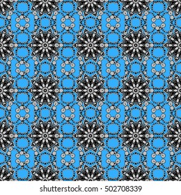 Oriental seamless pattern of white flowers and mandalas. Vector blue background.