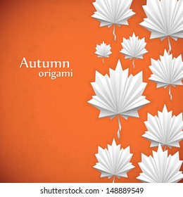 Origami autumn background. The folded colored paper  on the bright background.