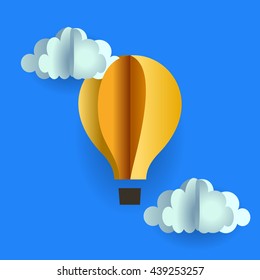 origami balloon gondola and clouds of yellow paper on blue