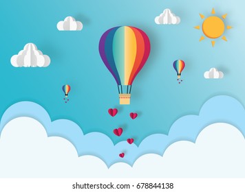 Origami of hot air balloon over the cloud and paper art of heart floating on the sky. Concept of love, sharing and wedding