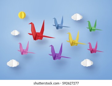 origami made colorful paper bird flying on blue sky with cloud . paper art and craft style.