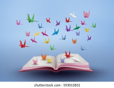 origami made colorful paper bird flying over open book and  blue sky. paper art and craft style.