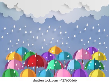 origami made colorful umbrella in the air with raining.paper art style.