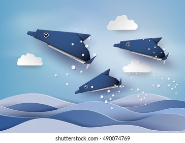 Origami made dolphin swimming in the sea  .paper art style.