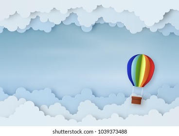 Origami made mobile paper of the hot air balloon in the air with cloud, copy space, paper art design and craft style. 