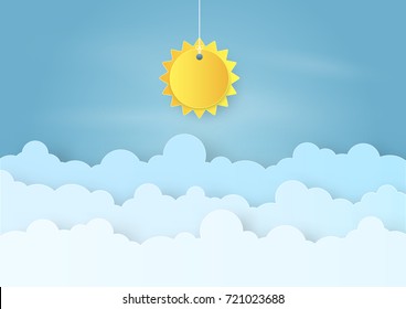 Origami made mobile paper sun and cloud on blue sky background. paper art design and craft style.