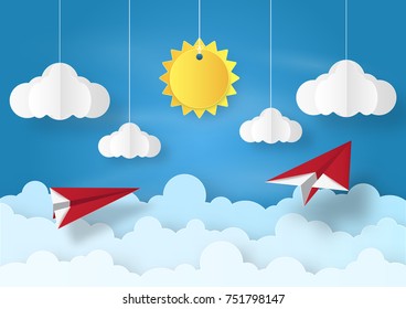 Origami made mobile paper sun and cloud with red plane flying on blue sky background. paper art design and craft style