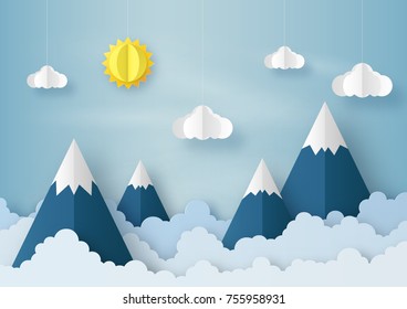 Origami made mobile paper sun, cloud and mountain on blue sky background. paper art design and craft style.