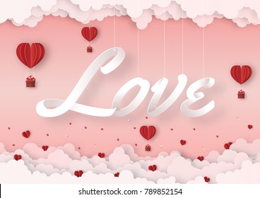 Origami made mobile paper of text " LOVE " with red hot air balloon float in the air and clouds, copy space, paper art design and craft style. Valentine's concept.
