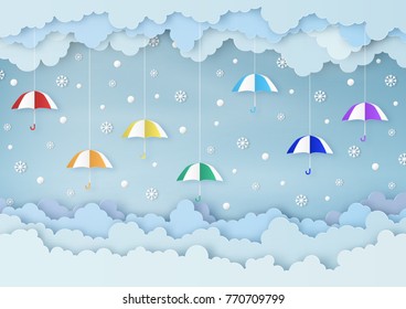 Origami made winter weather forecast of snowballs and snowflakes drop on the colorful umbrella mobile paper, paper art design and craft style. Christmas concept.
