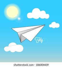 origami paper airplane flies on a blue sky during a clear sunny day
