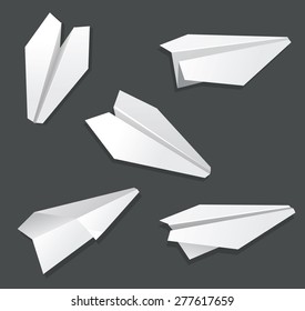 Origami paper airplane toy white on black.