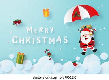 Origami paper art of Santa Claus make a parachute jump on the sky, Merry Christmas and Happy New Year