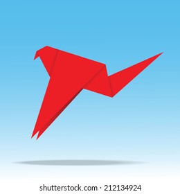 Origami paper bird on blue background