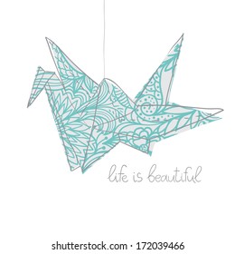 Origami paper crane with sign life is beautiful
