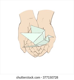 origami paper cranes in hands