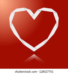Origami paper heart on the red background.