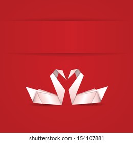 Origami, white folded paper swans on red background.