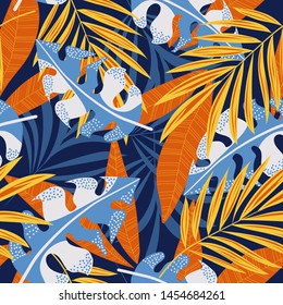 Original abstract seamless pattern with colorful tropical leaves and plants on blue background. Vector design. Jungle print. Flowers background. Printing and textiles. Exotic tropics. Fresh design.