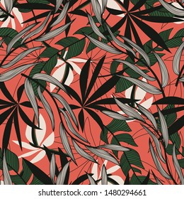 Original abstract seamless pattern with colorful tropical leaves and plants on red background. Vector design. Jungle print. Floral background. Printing and textiles. Exotic tropics. Summer.
