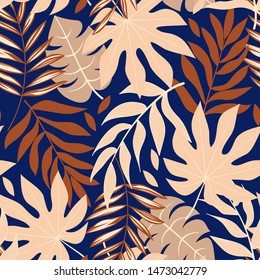 Original abstract seamless pattern with tropical leaves and bright plants on a blue background. The seal of the jungle. Vector design. On a floral background. Textiles and printing. Exotic, tropical.