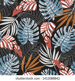 Original seamless pattern with bright plants and leaves on a dark background. Vector design. Jungle print. Textiles and printing.