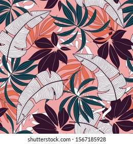 Original seamless tropical pattern with beautiful plants and leaves on pink background. Exotic tropics. Summer. Printing and textiles.  Beautiful seamless vector floral pattern.