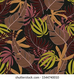 Original seamless tropical pattern with bright Burgundy and yellow plants and leaves on a brown background. Modern abstract design for fabric, paper, interior decor. Exotic jungle wallpaper.