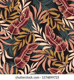 Original seamless tropical pattern with bright yellow and red plants and leaves on a black background. Seamless exotic pattern with tropical plants. Exotic wallpaper.