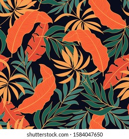 Original seamless tropical pattern with bright yellow and green plants and leaves on a dark background.Summer colorful hawaiian seamless pattern with tropical plants. Summer colorful hawaiian.
