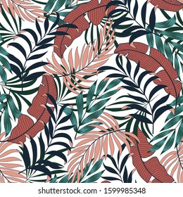 Original seamless tropical pattern with bright red and green plants and leaves on a white background. Modern abstract design for fabric, paper, interior decor. Exotic jungle wallpaper.