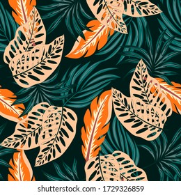 Original seamless tropical pattern with bright plants and leaves on a dark background. Beautiful print with hand drawn exotic plants. Vintage pattern.